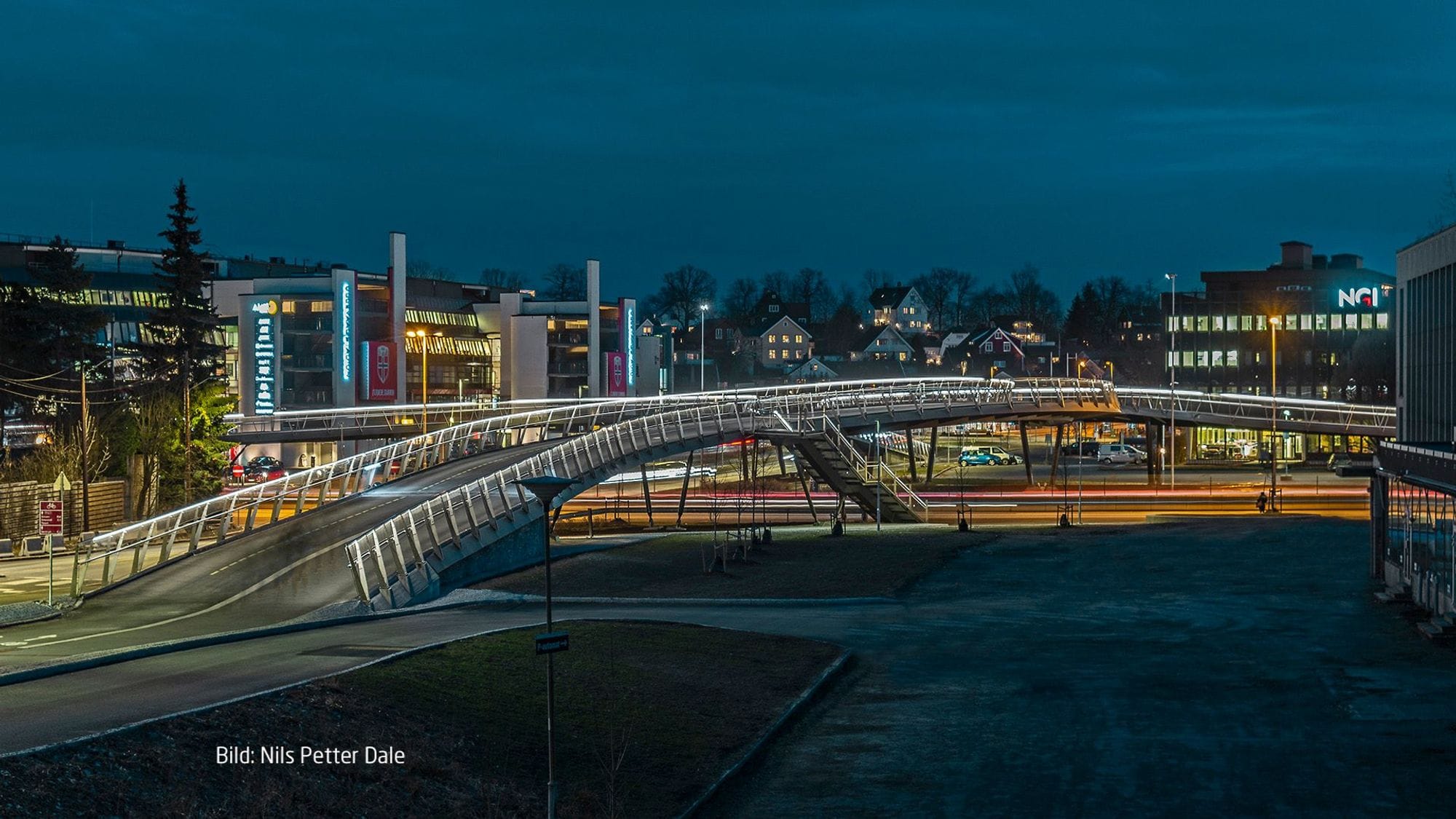 Footbridge in a city landscape, dark outside but the street lighting very sharp